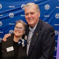 President Emertius Thomas Haas smiles with a colleague